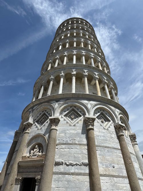 Free Iconic Leaning Tower of Pisa captured on a sunny day, highlighting its unique tilt and architectural details. Stock Photo