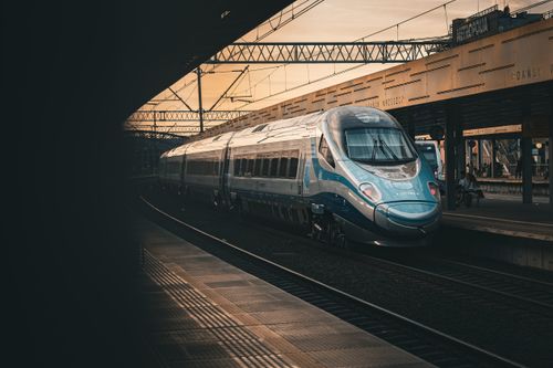 Free Sleek modern train at Gdańsk railway station during a moody golden hour sunset. Stock Photo