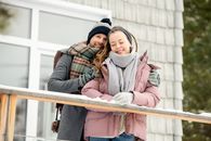 冬日，一对幸福的情侣在白雪皑皑的阳台上相拥