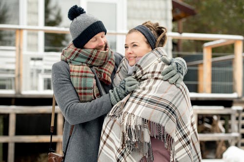 Man Holding Woman's Scarf