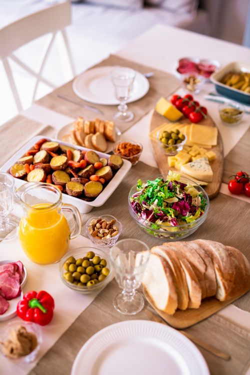 Free A colorful breakfast spread with bread, salads, and cheese on a table. Stock Photo