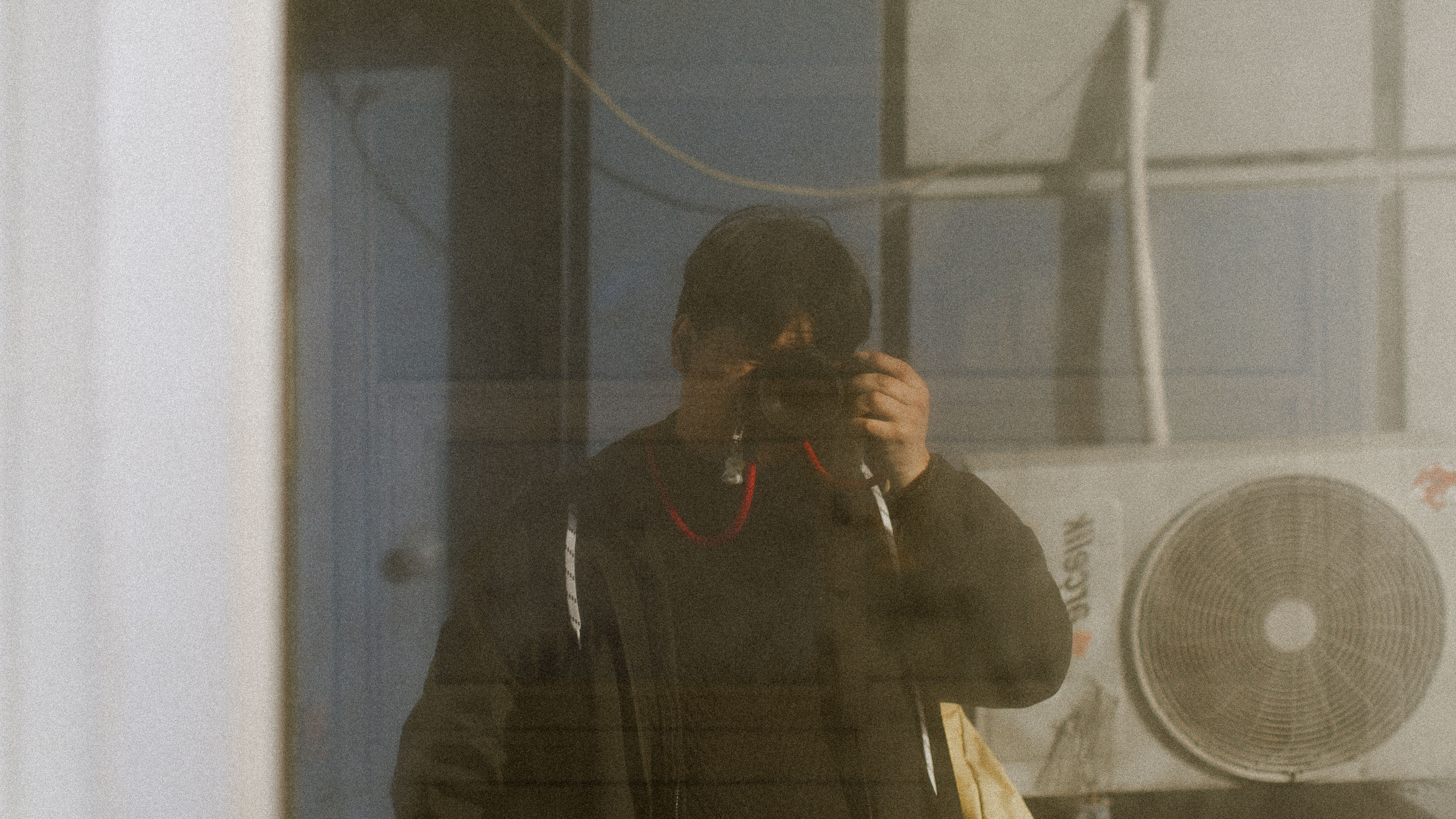 A candid mirror selfie inside the Daily Thread dressing room, fairy lights and a New Arrivals sign reflected in the glass