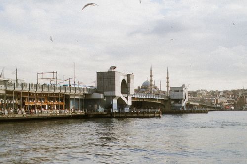 Free A view of the Galata Bridge and waterfront with Istanbul's iconic skyline and mosque in the background. Stock Photo