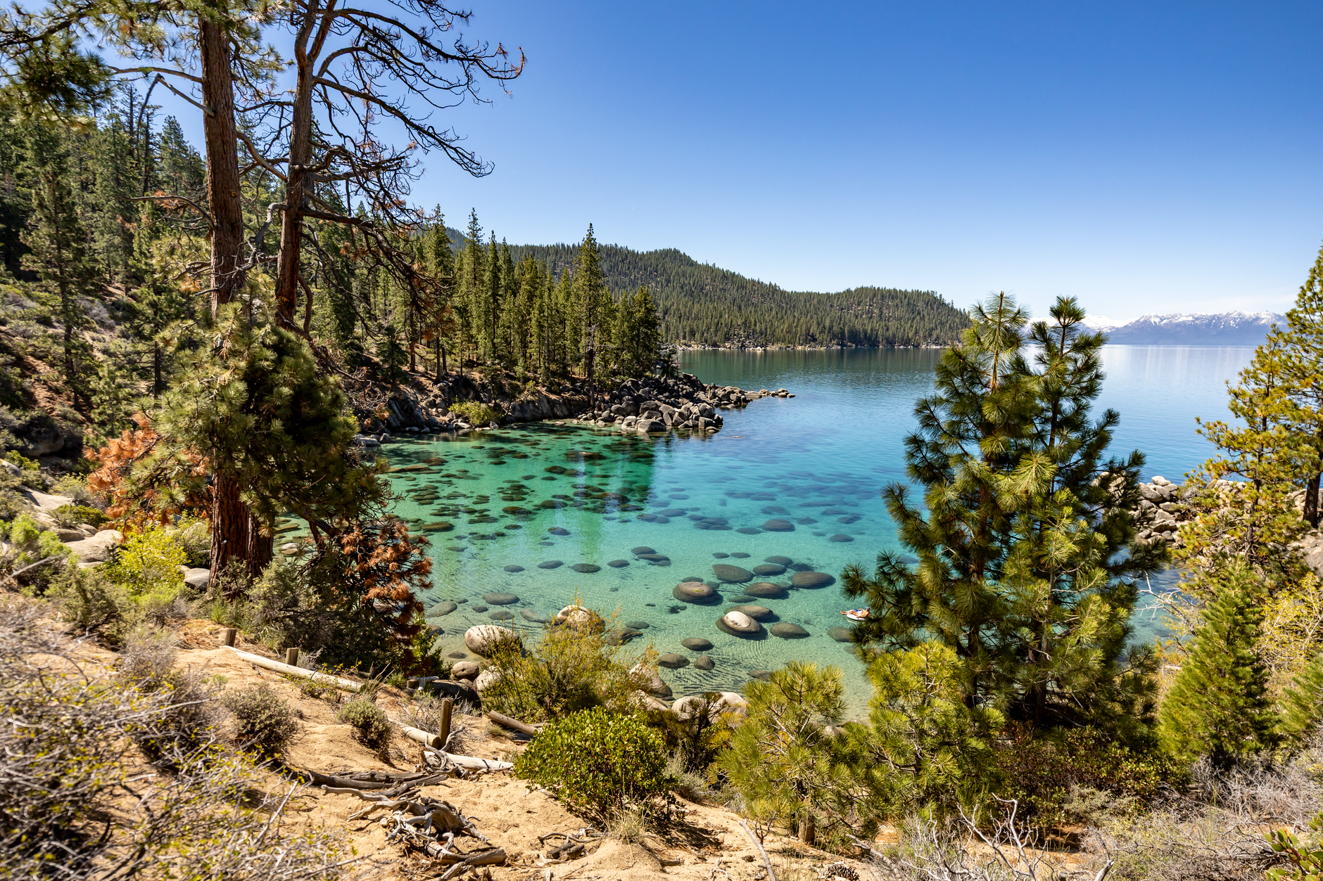 Solo hiker on a granite ridge above Lake Tahoe