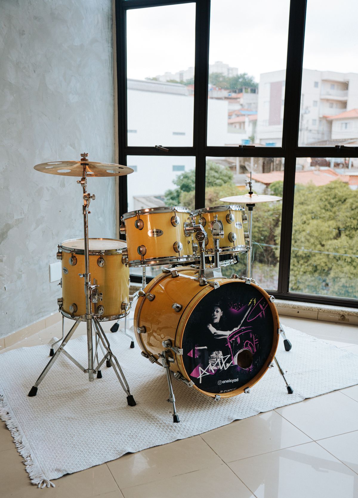 Yellow acoustic drum set in a contemporary indoor space