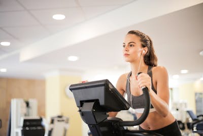 Personal trainer coaching client with dumbbells