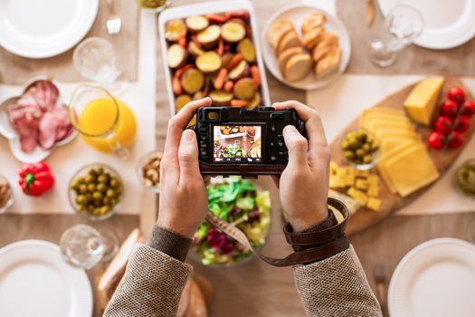 Photograph of a colorful breakfast table setting viewed through a camera screen.