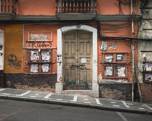 Free Weathered building facade with graffiti and posters on a Bolivian street. Stock Photo
