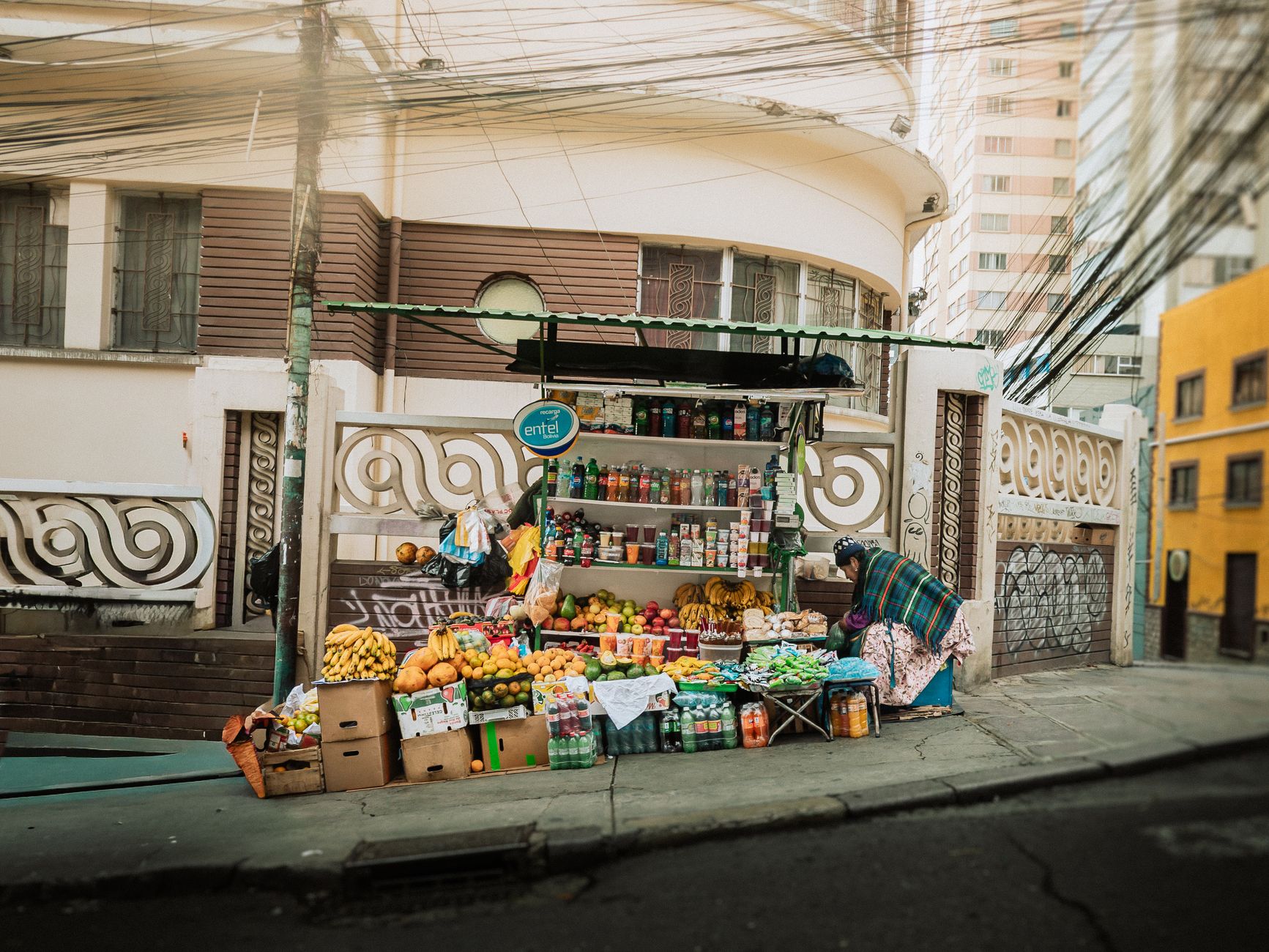 Street market stall in Bolivia with colourful fruit and packaged goods on display
