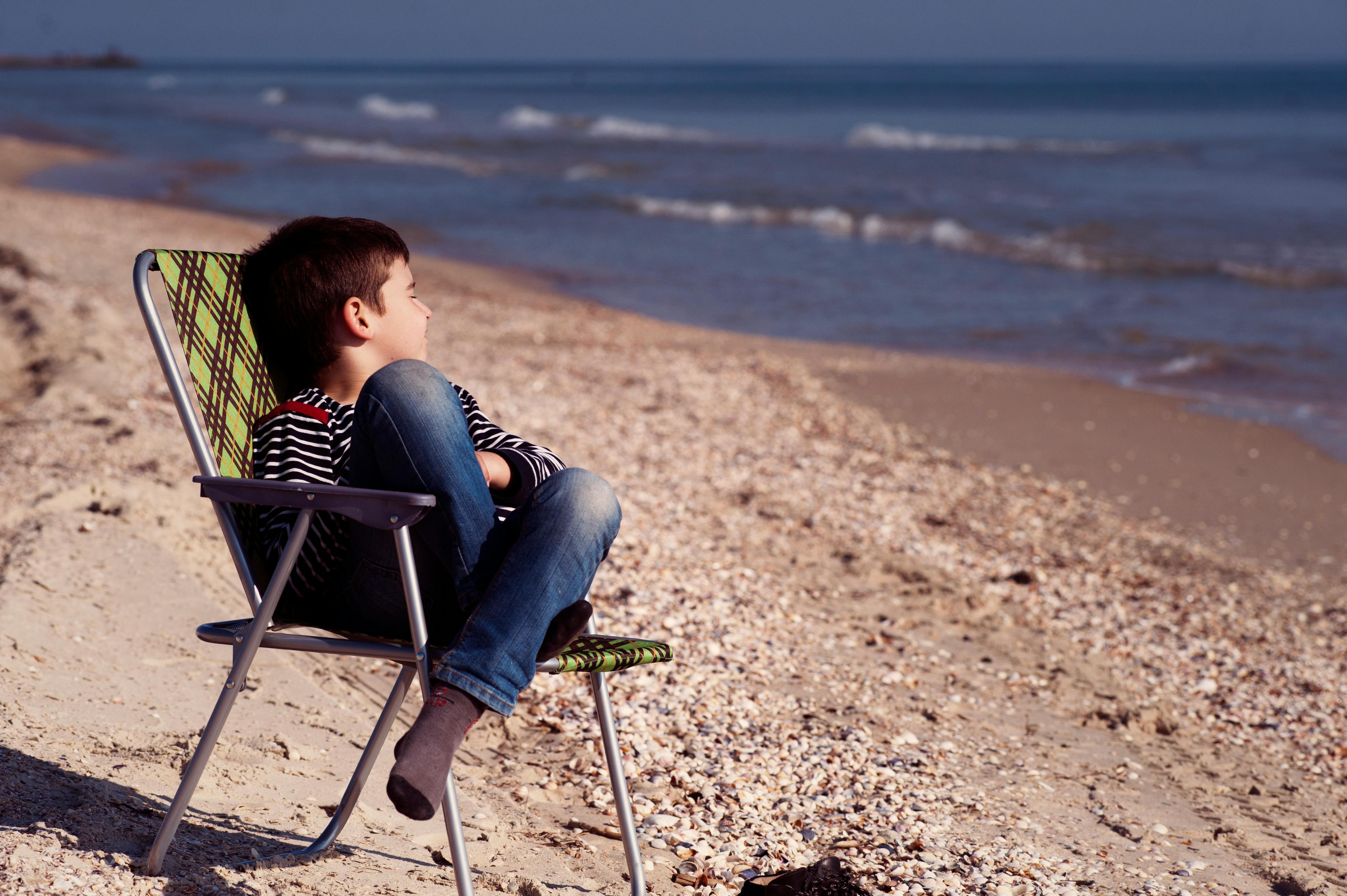 Boy Sitting On Chair Free Stock Photo