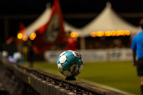 Free Close-up of a soccer ball on the sidelines at a night stadium event Stock Photo