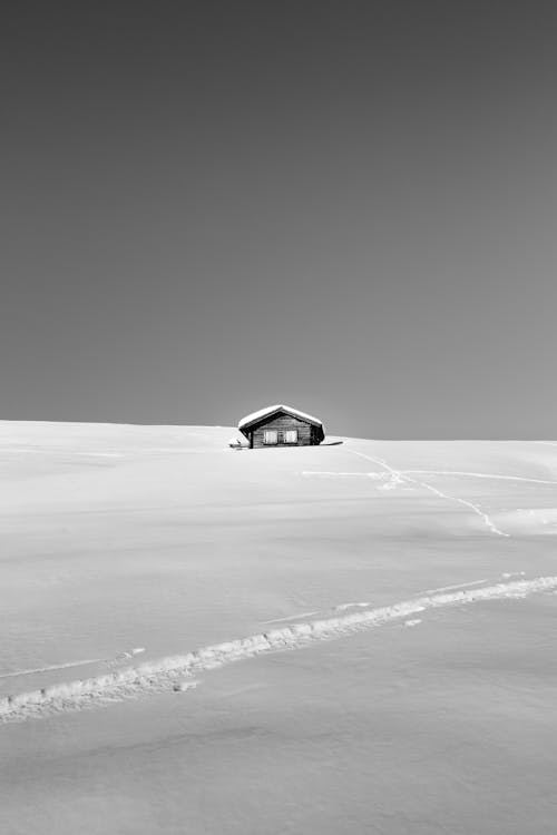 Lonesome remote cottage on snowy valley