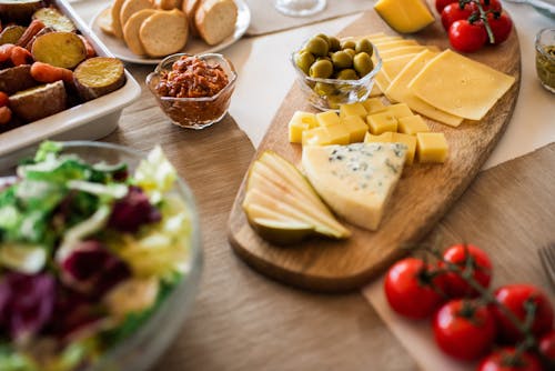 Close-Up Photo Of Cheese On Wooden Tray