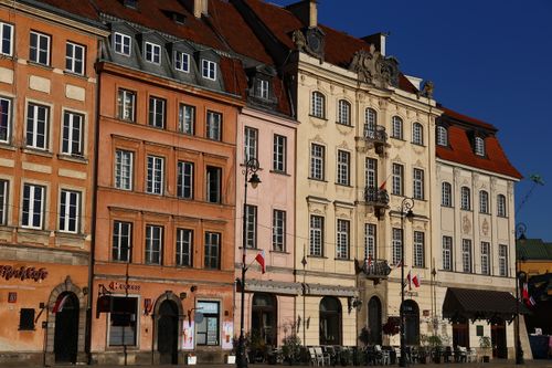 Free Charming historic townhouse facades in Warsaw's old town under clear blue sky. Stock Photo
