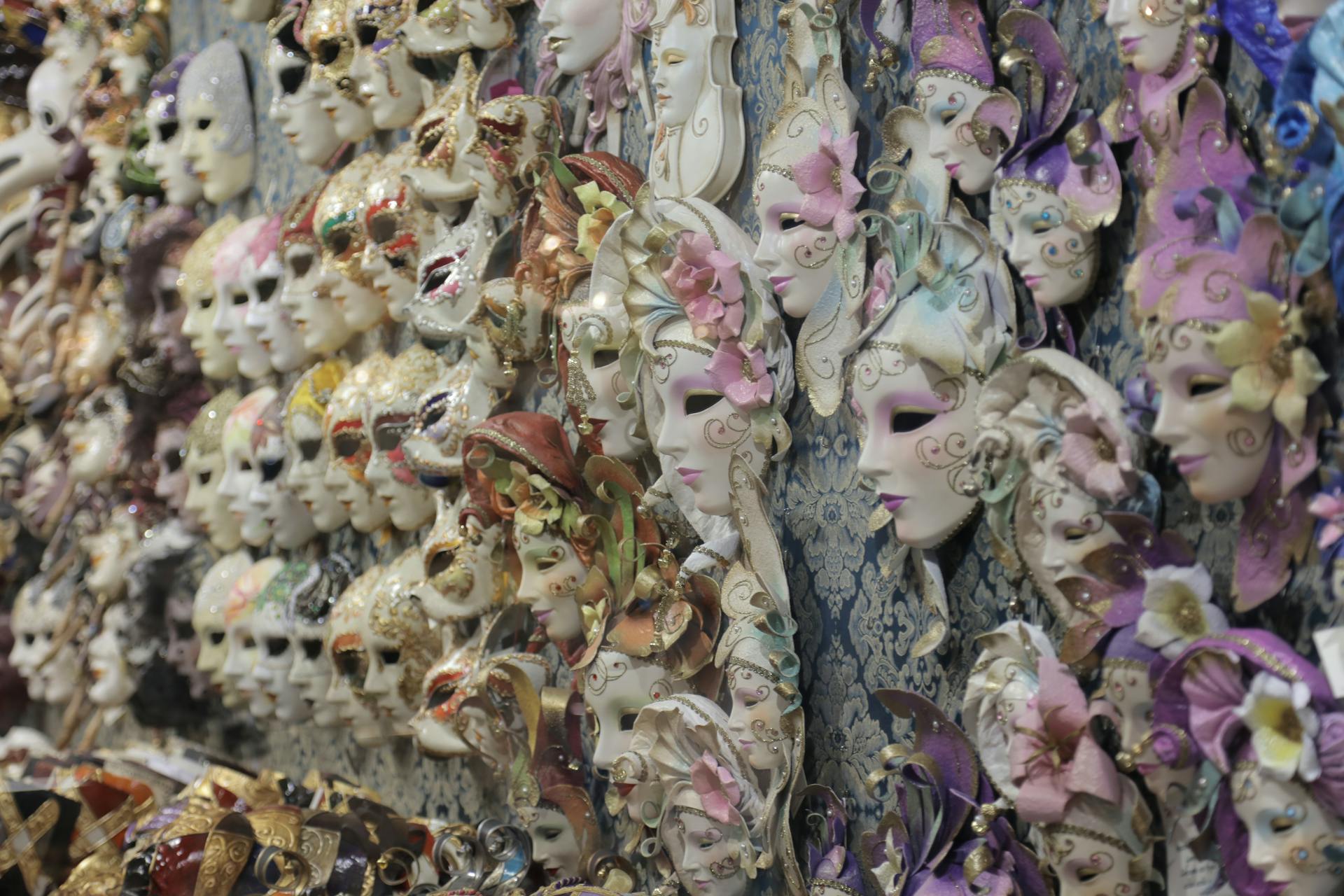 A vibrant collection of decorative masks displayed on a wall