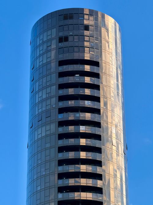 Free Tall cylindrical skyscraper against blue sky in Box Hill, Victoria, Australia Stock Photo