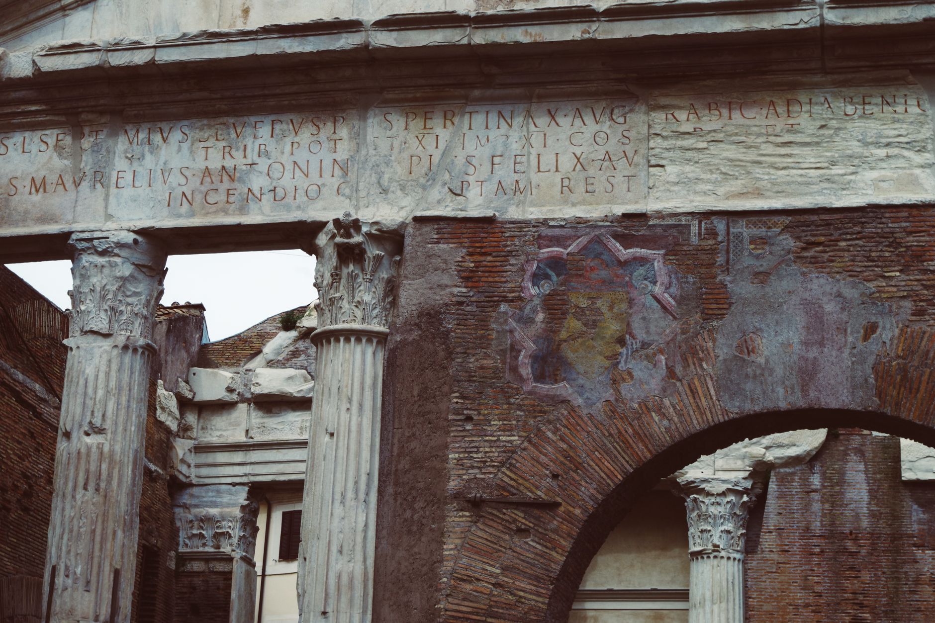 Close-up of Roman ruins showcasing inscribed columns and worn brickwork.