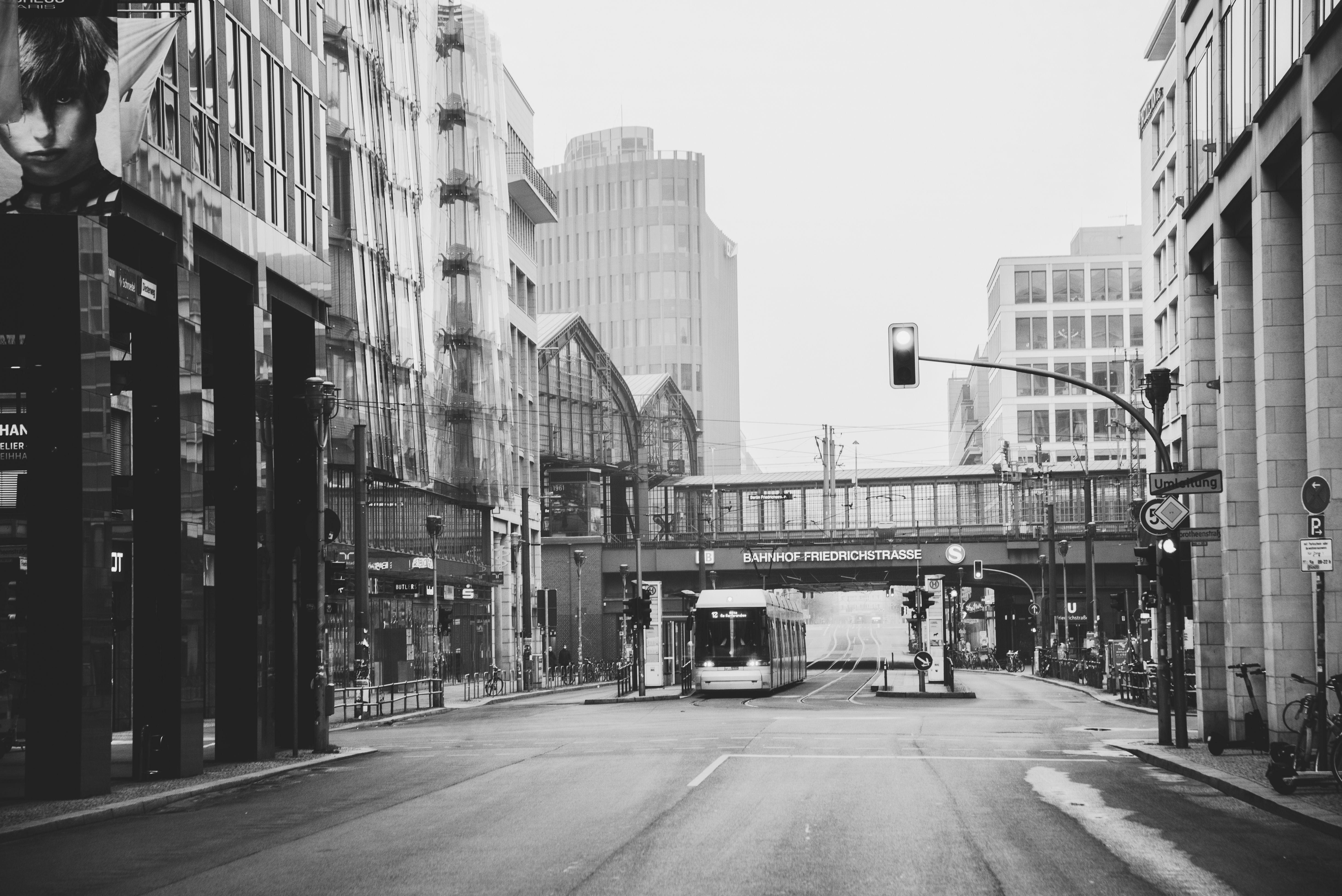 Monochrome view of Friedrichstrasse train station in Berlin, showcasing urban architecture and street life.