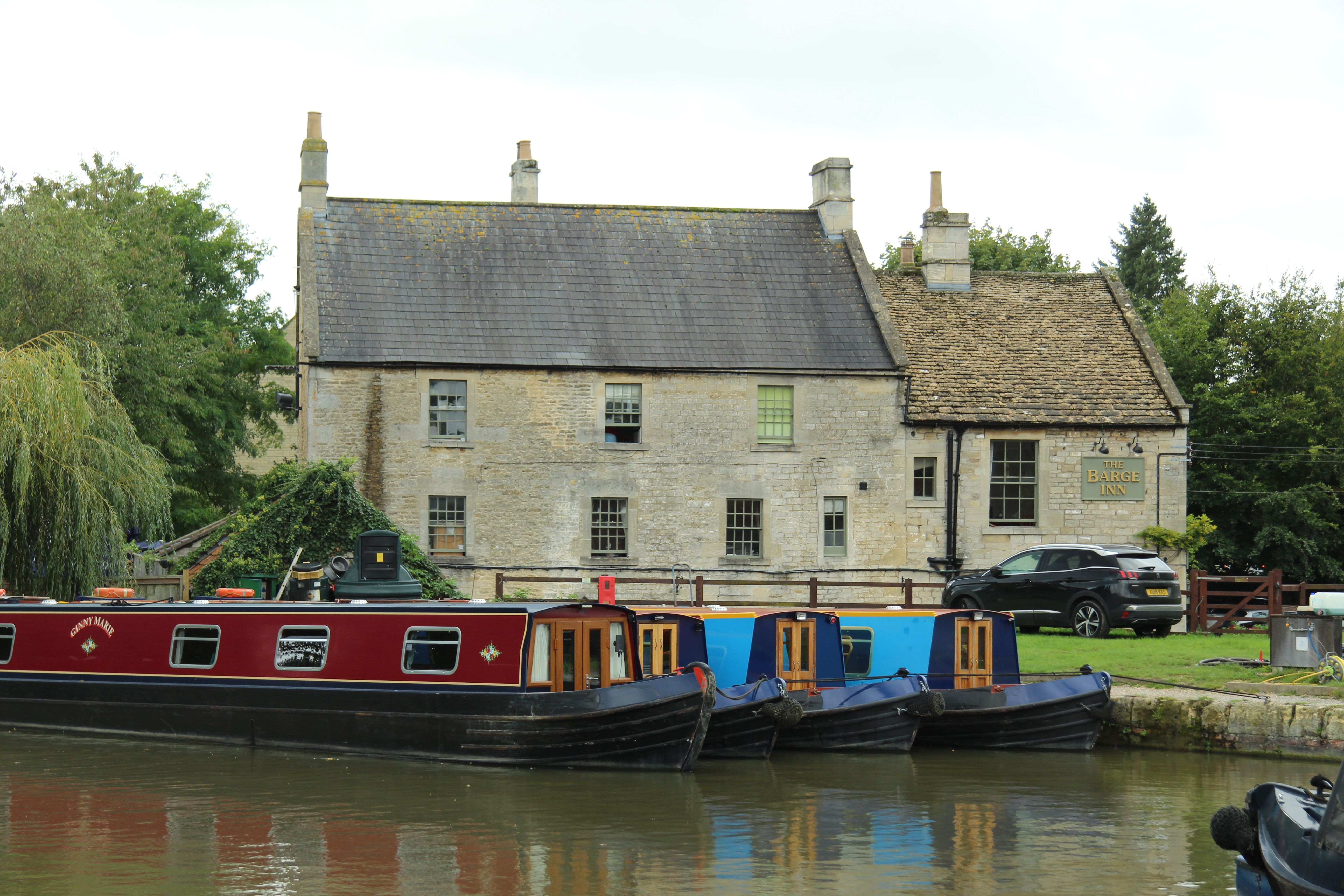 Thames Path near Reading with narrowboats moored along the bank