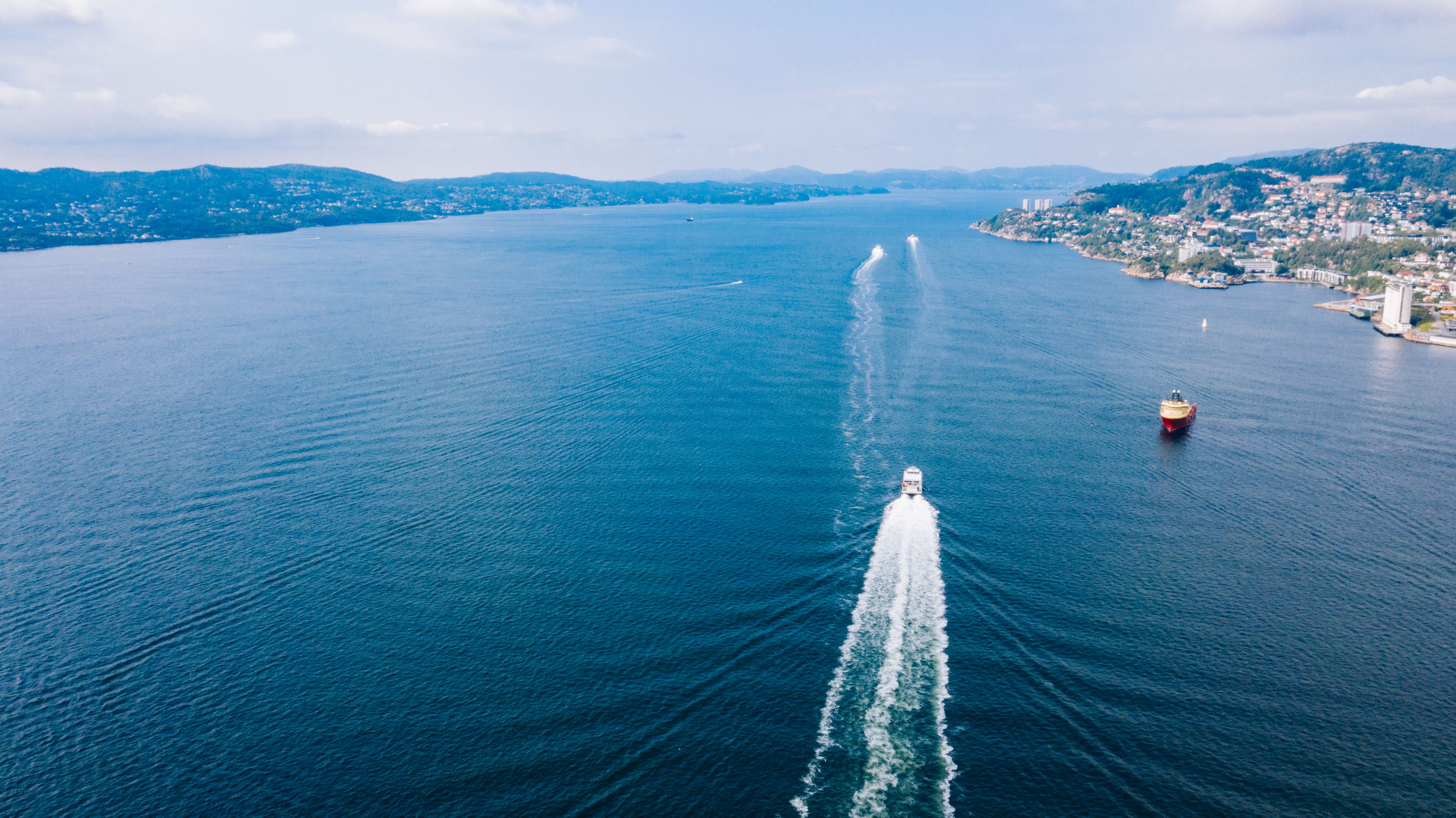A stunning aerial view of boats navigating the waters near Bergen, Norway. Perfect for travel enthusiasts. A stunning aerial view of boats navigating the waters near Bergen, Norway. Perfect for travel enthusiasts.