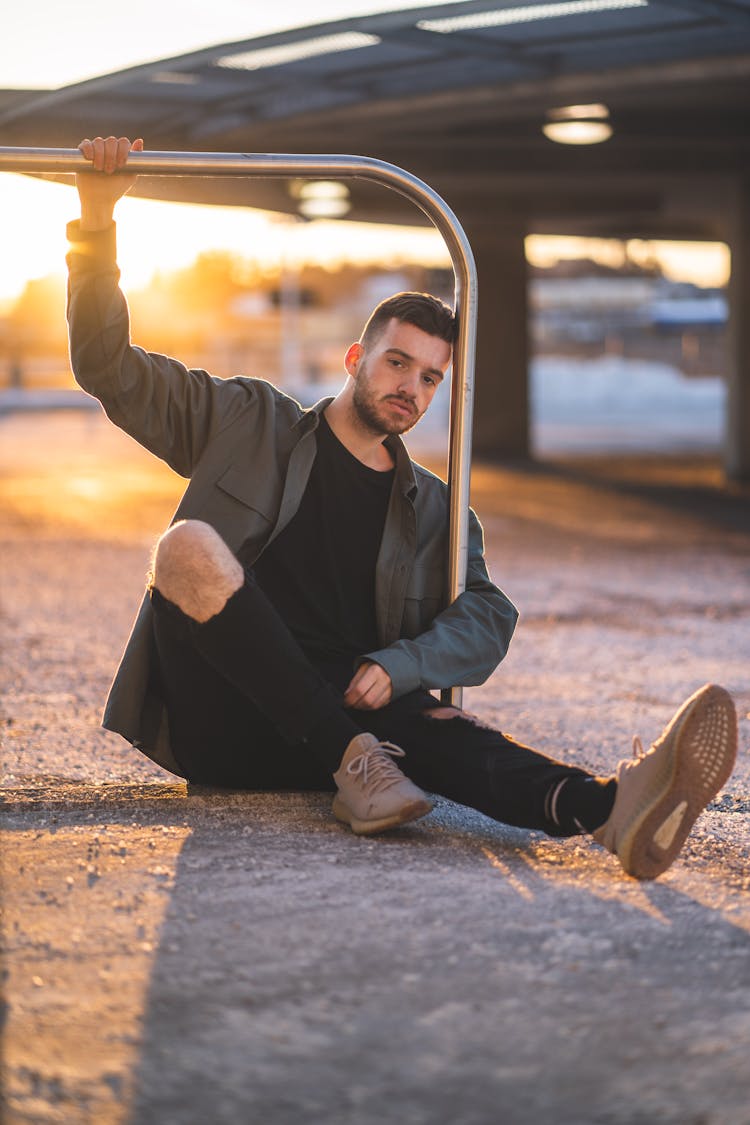 Photo Of Man Sitting On The Ground