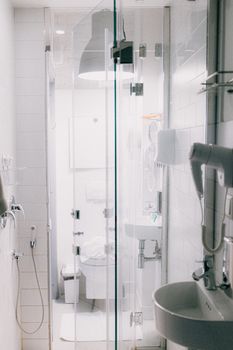 Stylish contemporary bathroom featuring a clean, minimalist design with a glass shower enclosure.