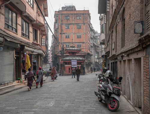 Free A bustling street in Kathmandu, featuring traditional Nepalese architecture and daily life activities. Stock Photo