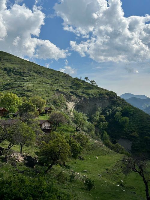 Free Breathtaking view of lush green hills and cloudy sky in Northern Caucasus. Stock Photo