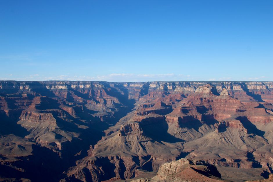 Stunning view of the Grand Canyon with colorful rock formations and clear skies