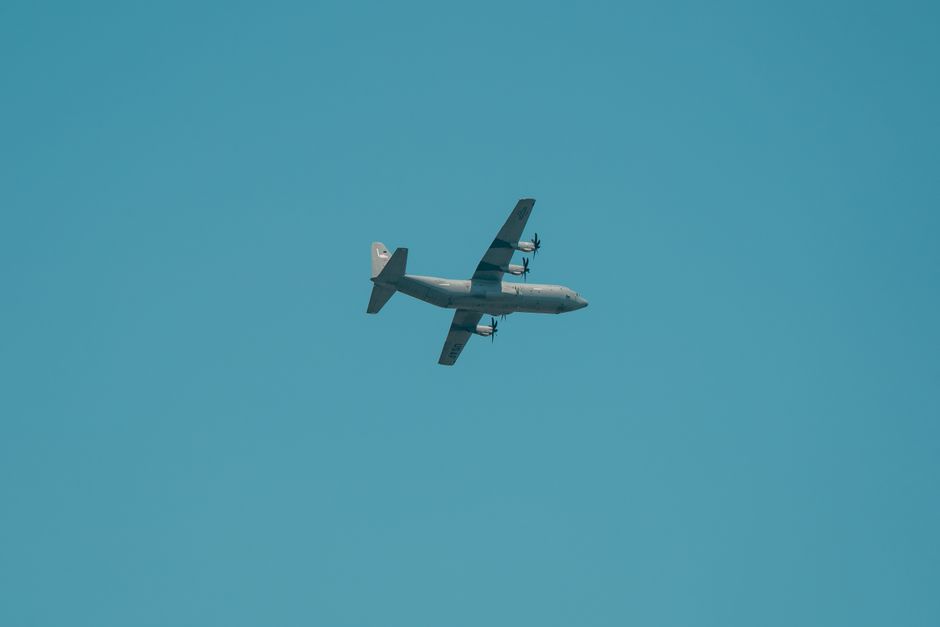 Propeller aircraft flying in clear blue sky, captured from below. Fujisawa, Kanagawa, Japan.