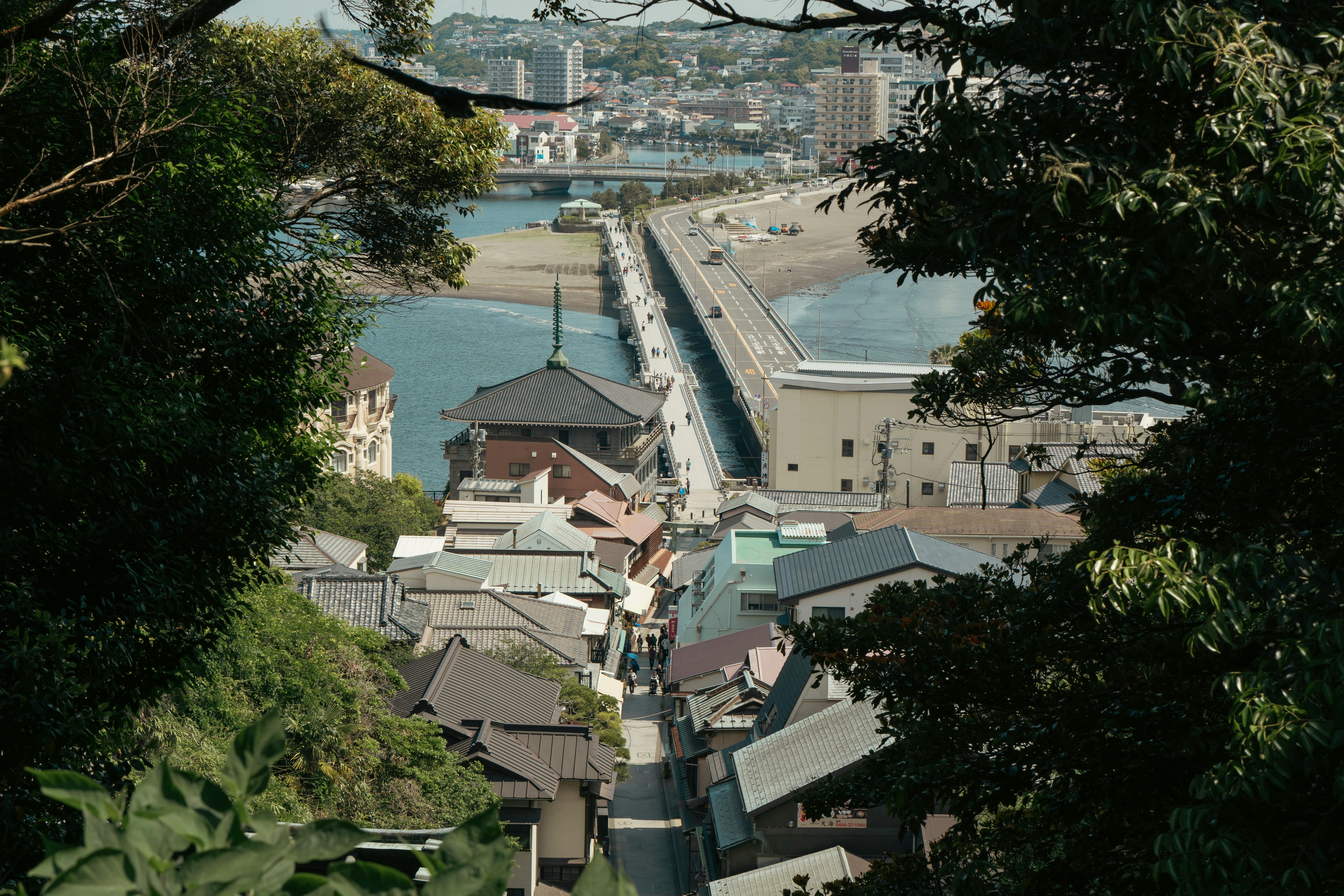 Explore the beautiful Enoshima Island in Kanagawa, Japan, captured from above, showcasing its iconic bridge and town.
