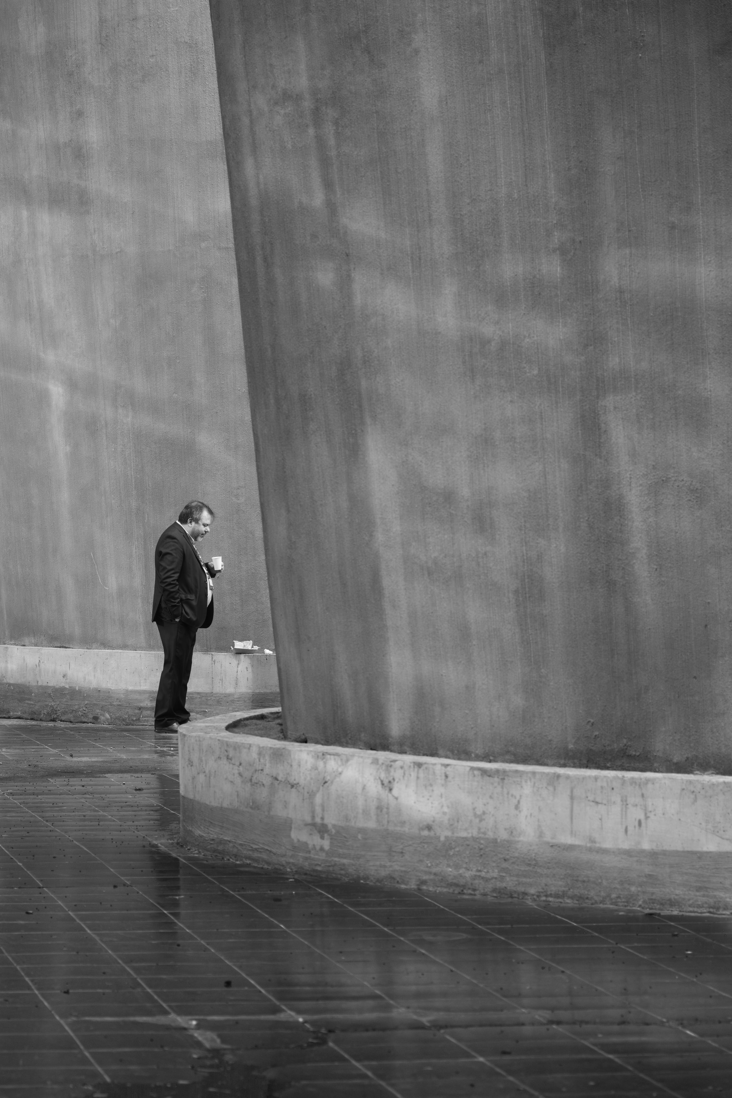 Man in Suit Standing Next to Modern Architecture · Free Stock Photo