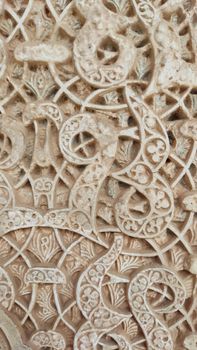 Close-up of detailed Islamic geometric patterns in the Alhambra, Granada.