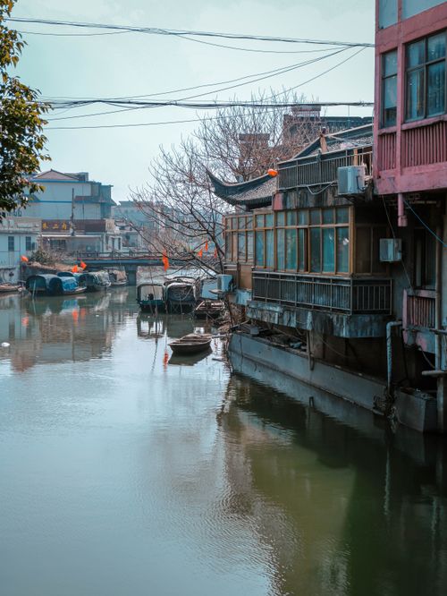 Free Picturesque view of traditional canal houses along a waterway in an ancient water town setting. Stock Photo