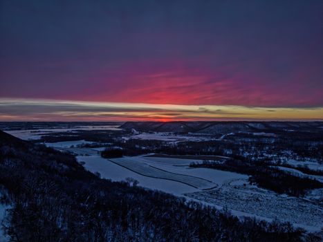 Captivating sunset view over snowy landscapes in Weaver, Minnesota during winter.
