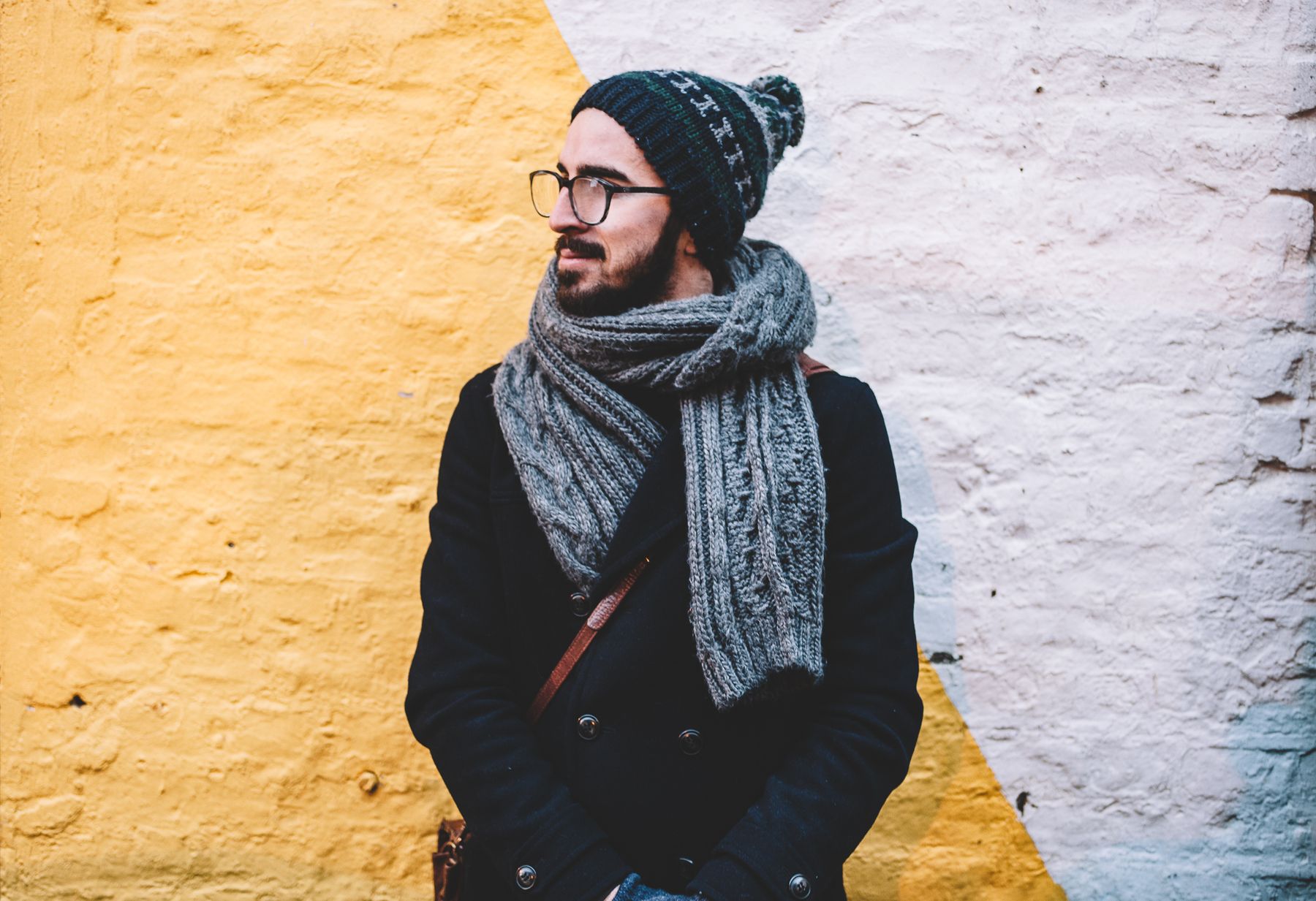 Man wearing a tailored menswear jacket in a refined city setting