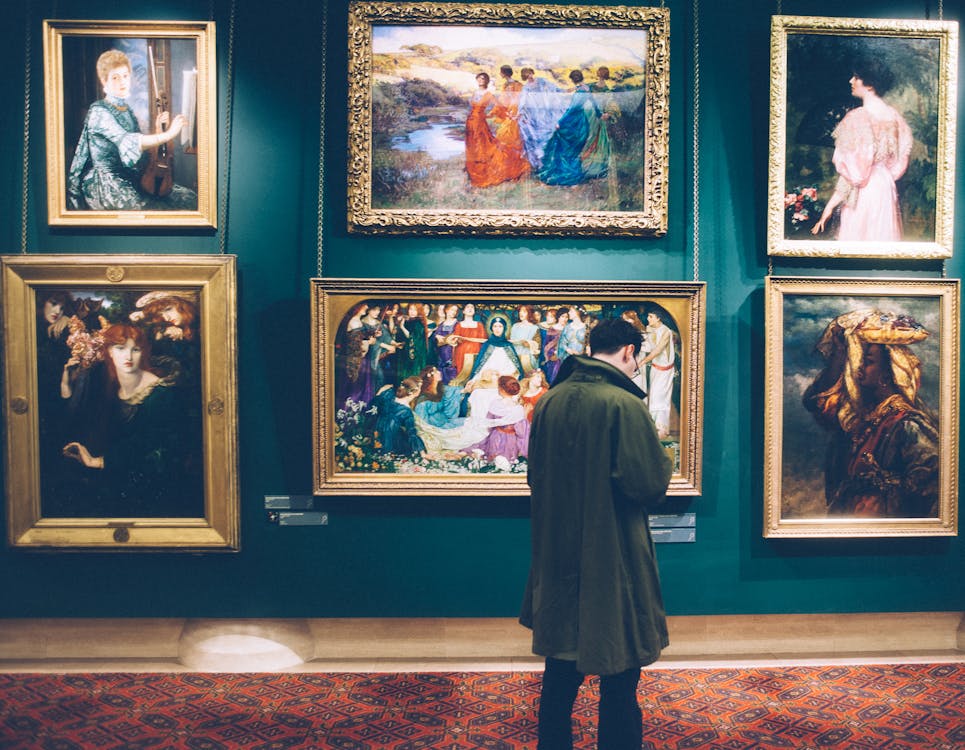 Free Man Standing in Front of Paintings Stock Photo