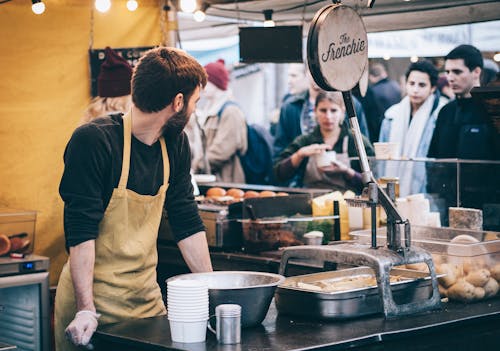 Man Standing in Front of Bowl and Looking Towards Left