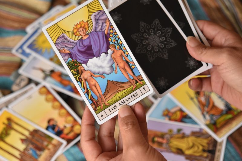 A close-up of a tarot card reading session focusing on The Lovers card, symbolizing relationships and choices.