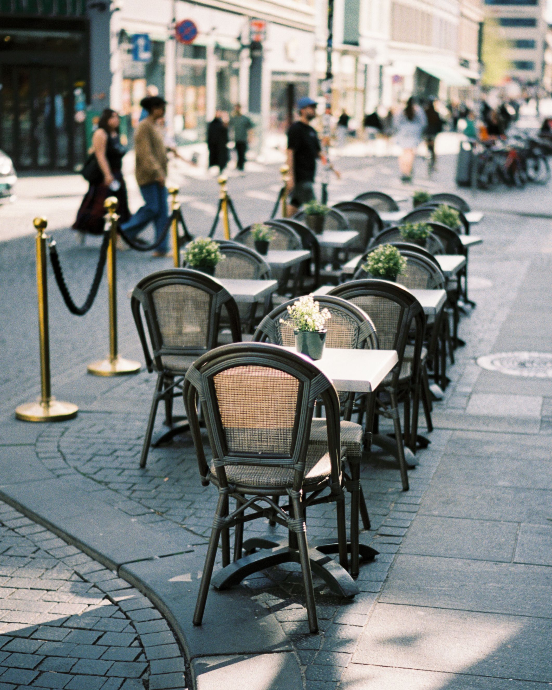 Charming outdoor cafe seating on a cobblestone city street, perfect for al fresco dining.