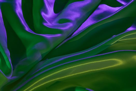A vivid display of flowing iridescent fabric creating a mesmerizing futuristic abstract background.