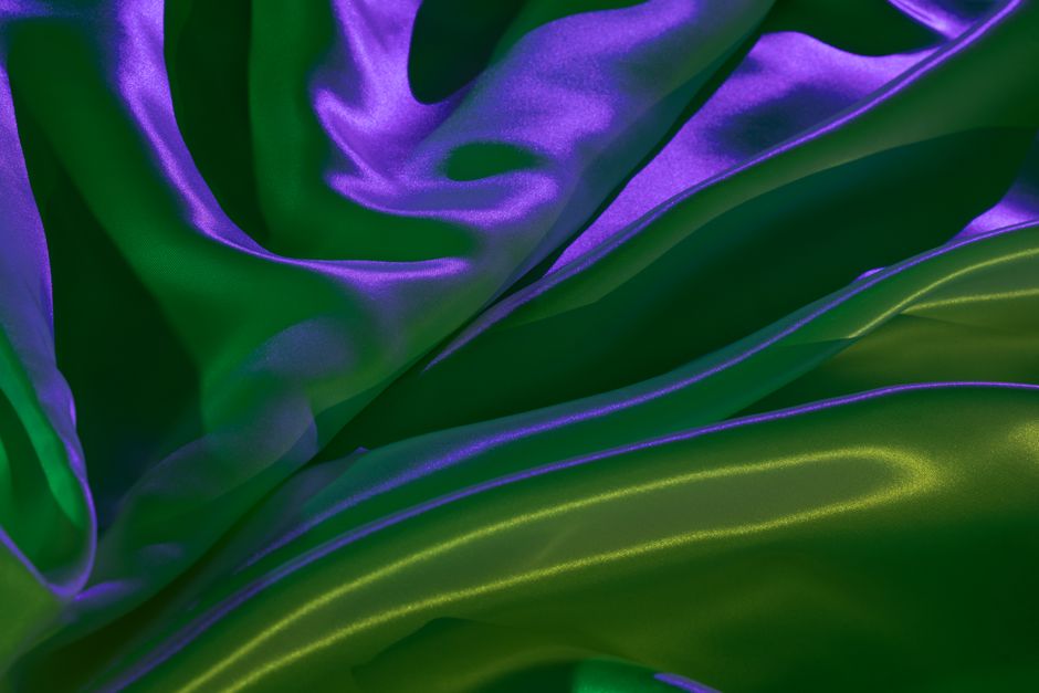 A vivid display of flowing iridescent fabric creating a mesmerizing futuristic abstract background.