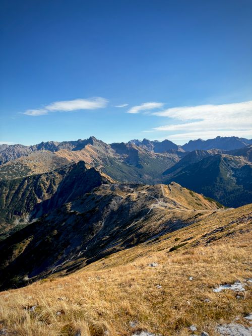Free Breathtaking view of Tatra Mountains under clear blue sky during autumn. Stock Photo