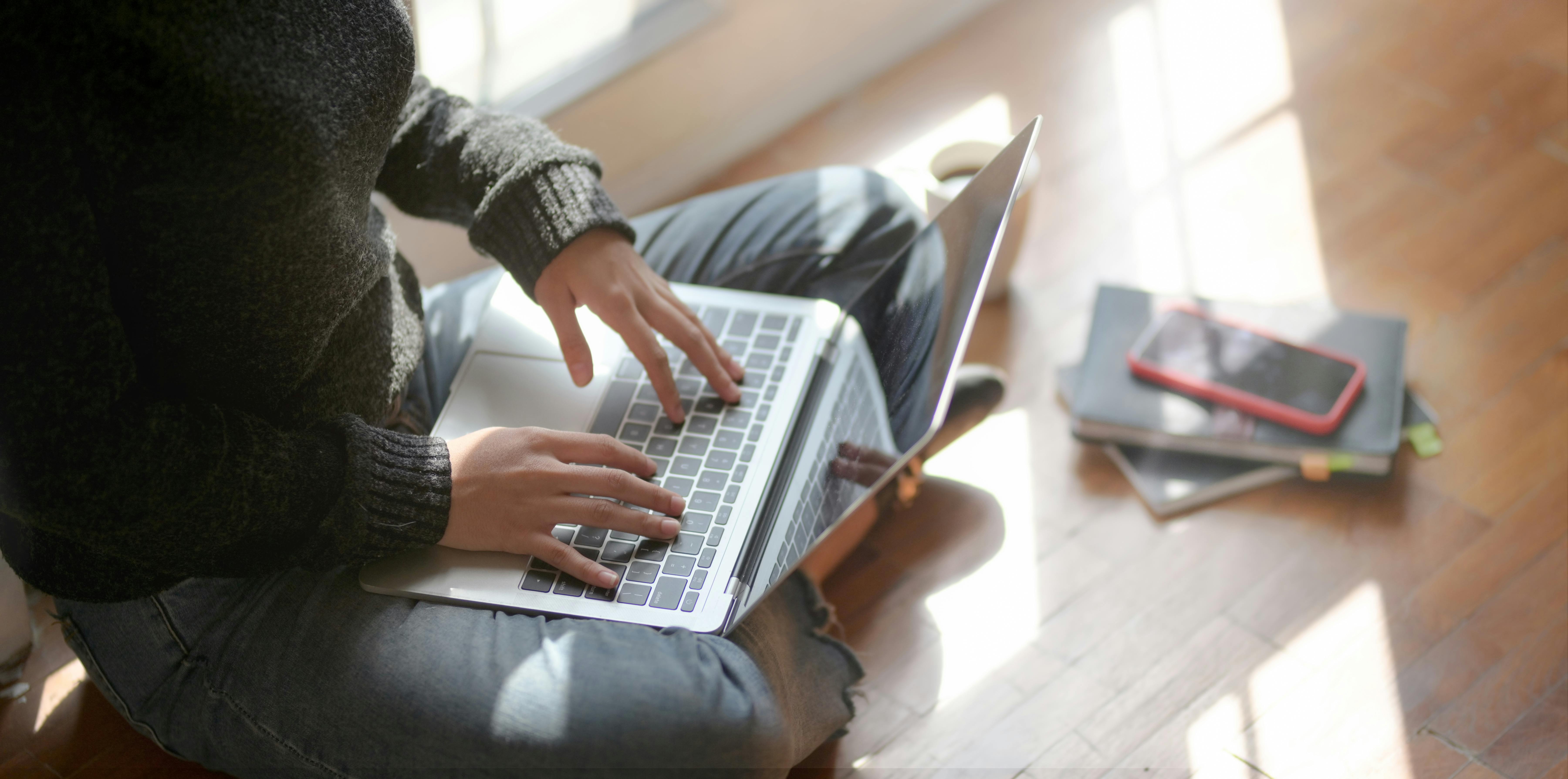 Woman Sitting On the Floor Using Laptop