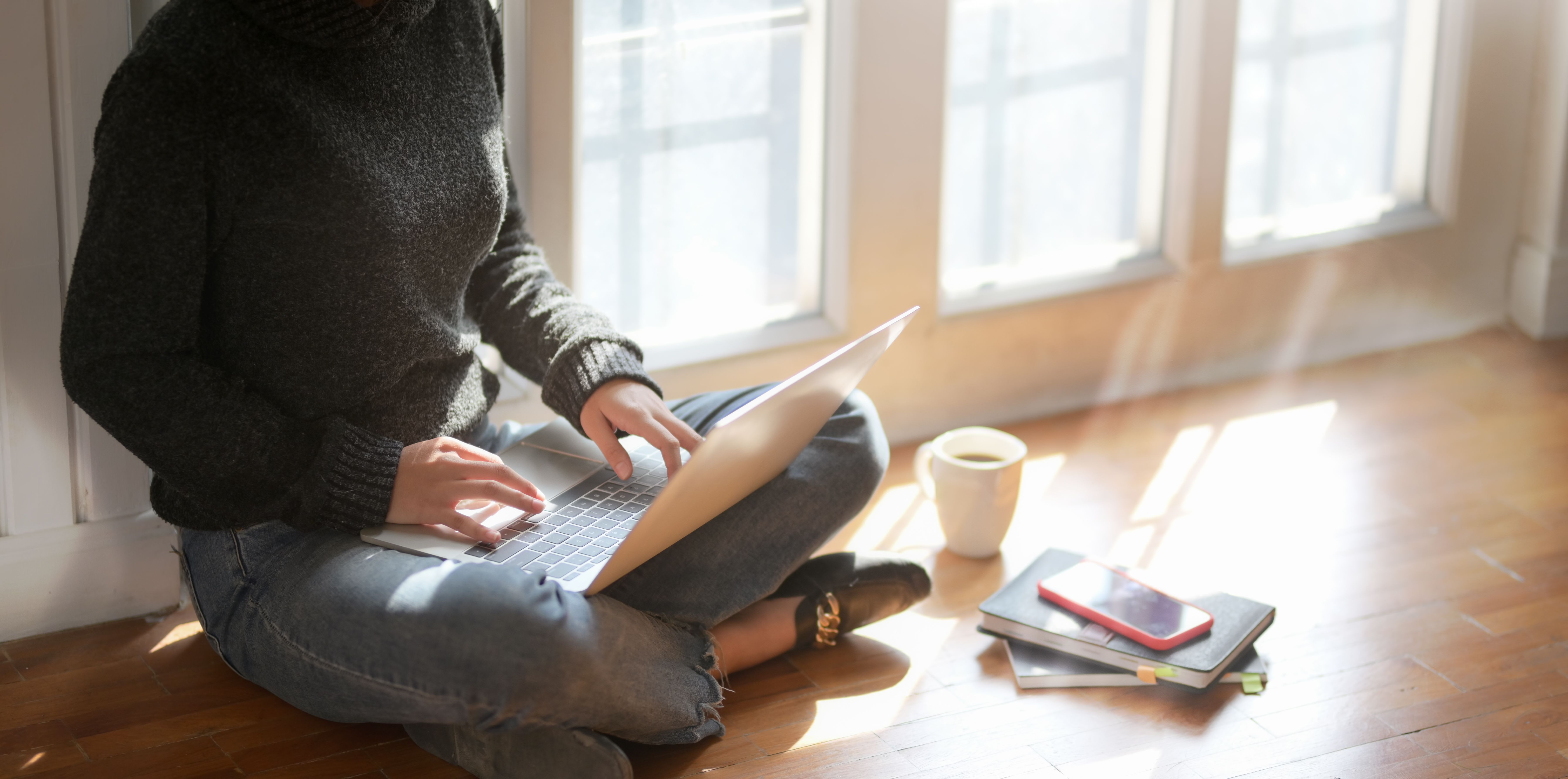 Woman resting head on desk, looking exhausted in the early afternoon at work