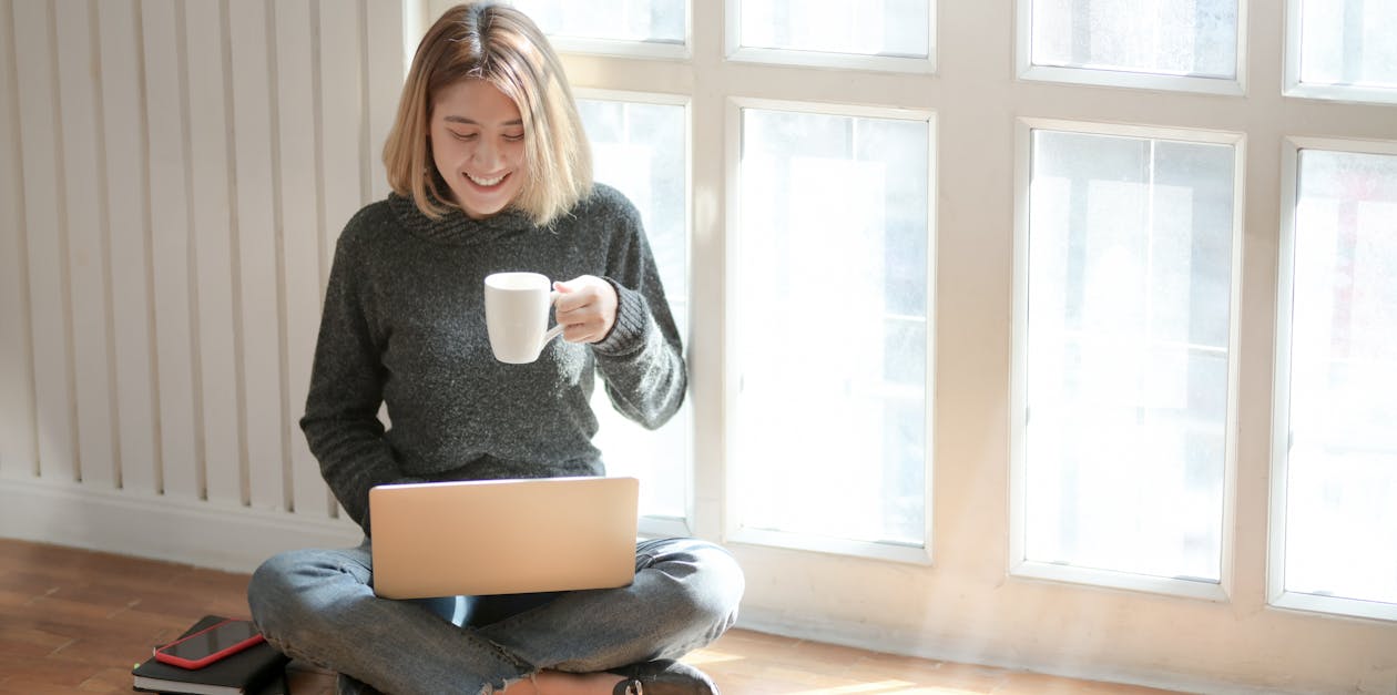 Woman in Gray Sweater Drinking Coffee 