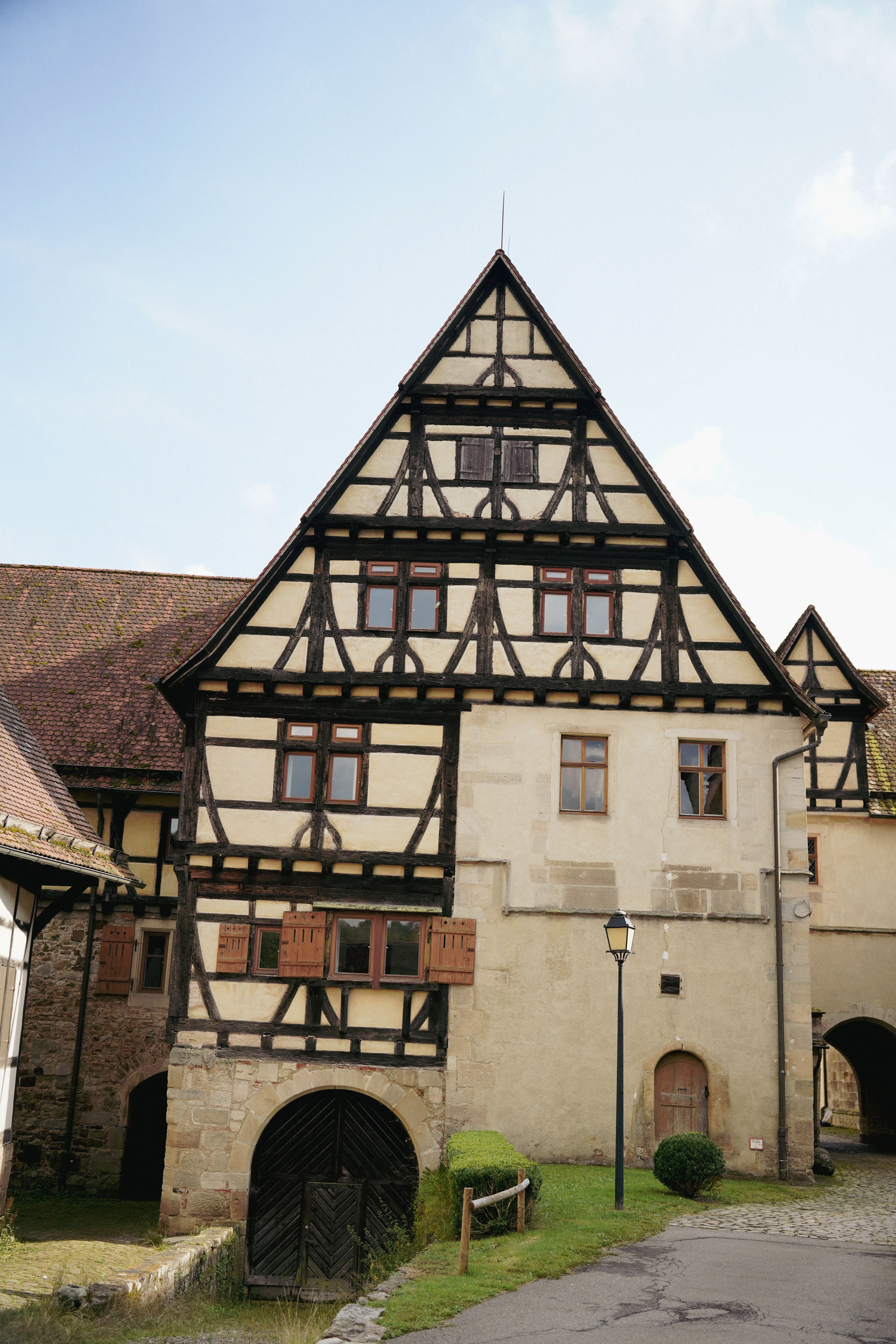 Classic half-timbered house set in a charming European village, showcasing traditional architectural style.