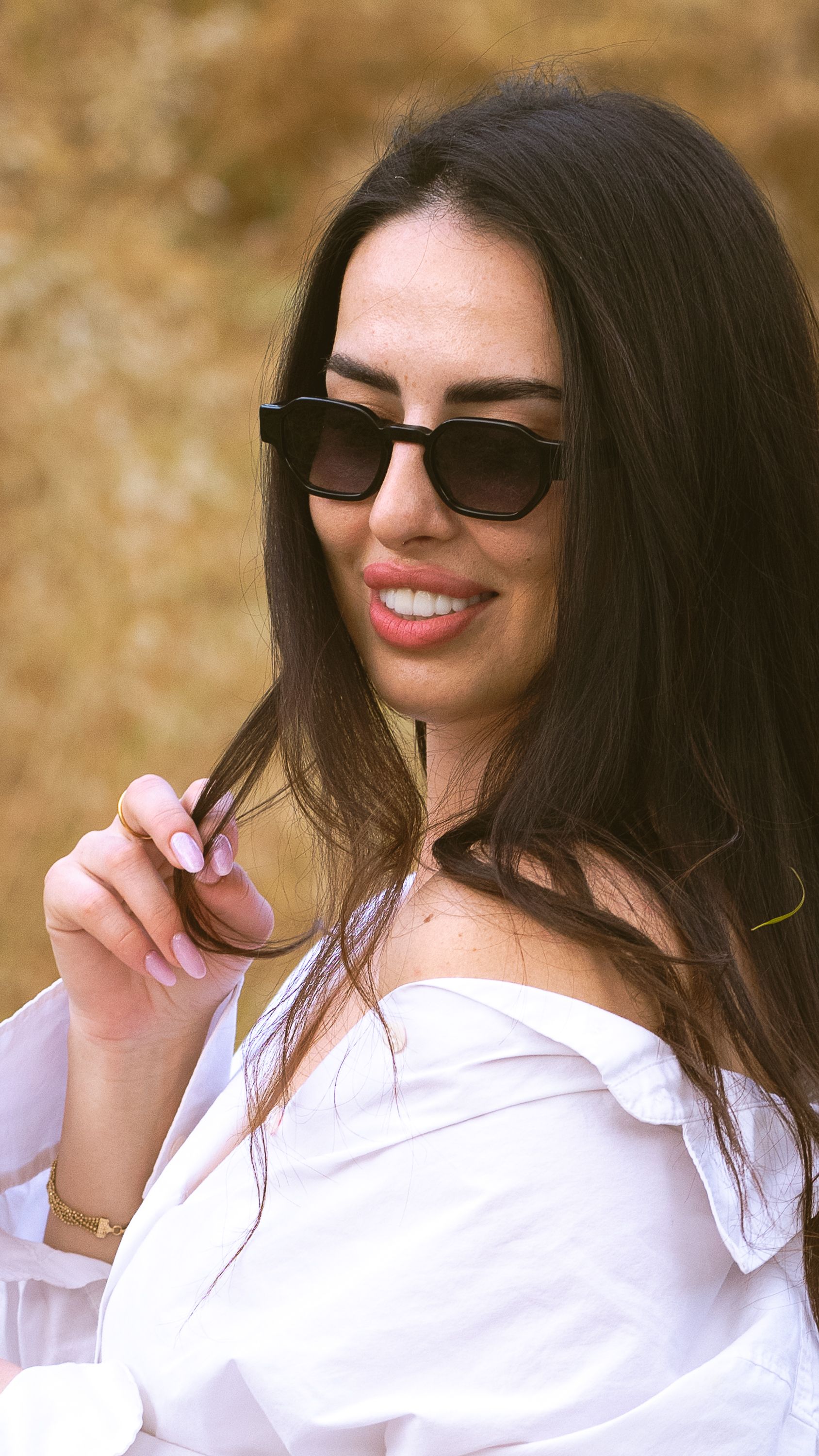 Stylish Woman Posing Outdoors in Sunglasses · Free Stock Photo