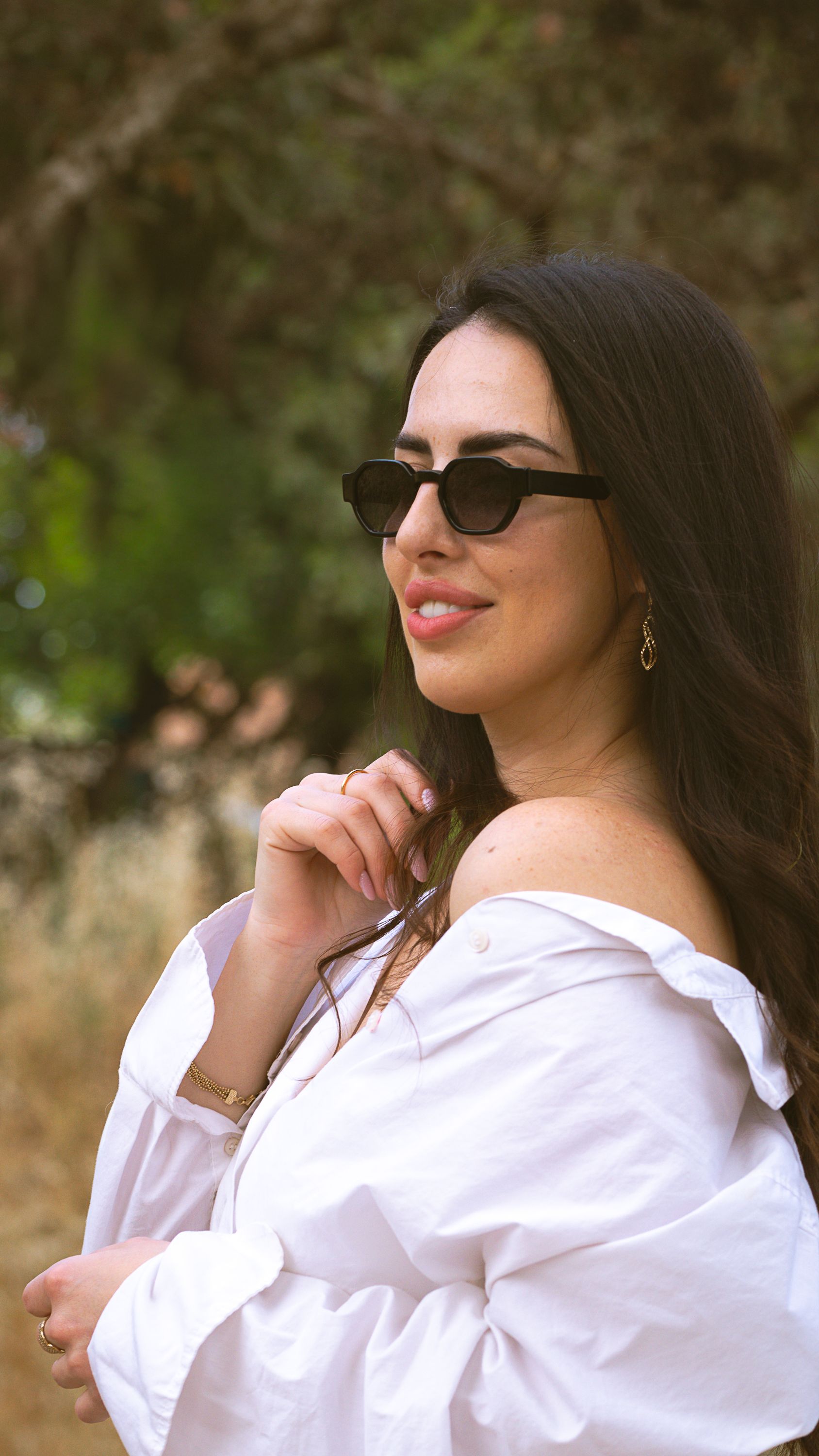 Stylish Woman Posing Outdoors in Sunglasses · Free Stock Photo