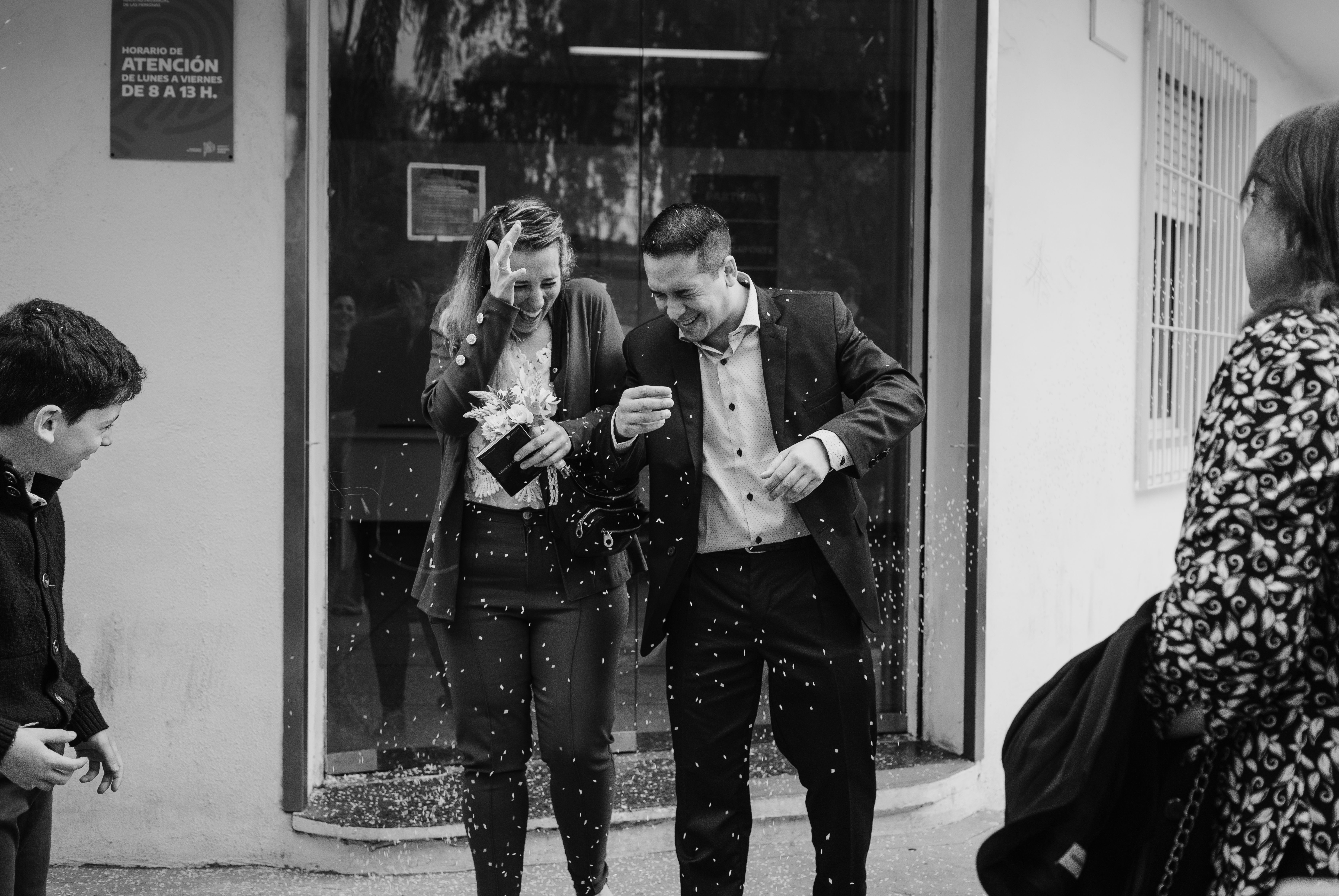 A joyful couple celebrating their wedding outside. Captured in black and white for a classic feel.